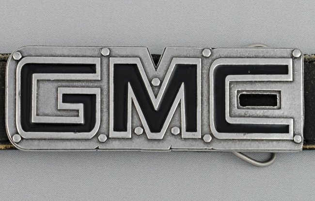 cut-out GMC logo belt buckle, black enamel letters and bolts