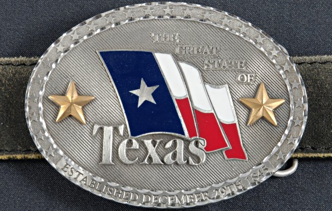 oval belt buckle with Texas state flag and gold stars