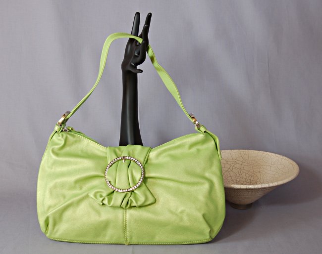 lime green flap bag, zipper top, adjustable single shoulder strap with nickel polish grommets and buckles, magnetic gathered flap with rhinestone studded 