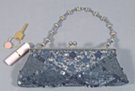 gray mini short shoulder bag/clutch. sequined and beaded with retractable beaded strap. satin lined with key pocket. 47" silver-tone chain included.
