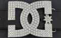 rhinestone belt buckle showing interlocking "D" and "G"