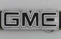 cut-out GMC logo belt buckle, black enamel letters and bolts