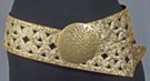 3" textured wide belt with rivets and cut-outs; 3.5" circular distressed metal buckle; rides low on hips with extra long overhang