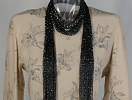 black and silver fishnet foil scarf on beige silk blouse