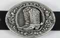 oval pewter western belt buckle with cowboy boots and spurs