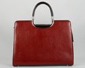 brief purse with detachable shoulder sling; zipper close