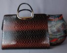 brown to black alligator embossed brief/purse with detachable shoulder sling; zipper close