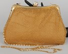 small gold pouchette with rhinestone studded acorn clasp
