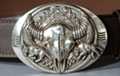silver-tone bison skull buckle, native american background