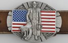 belt buckle, cowboy with saddle and lariat, American flag behind