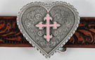 heart-shaped belt buckle with enameled pink fleur-de-lis cross in center