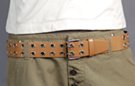 leather belt with double rows of metal eyelets, double prong roller buckle and plain leather retainer