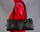 black east-west "swayback" shoulder bag with ornamental chrome roller buckle