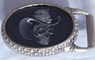 Oval 3-D belt buckle, skull with hat in dark, hidden money locket