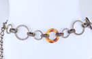 chain belt: medium and large cross-hatched antique gold rings accented by two large amber doughnuts, all joined by double textured antique gold chain links; extension chain formed of alternating short smooth and long stippled twisted links tipped by tiny ball
