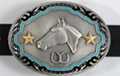 big oval western belt buckle with horse head, gold stars and double horseshoes