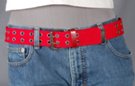 1-1/2" red double grommet web belt with nickel polish double prong roller buckle, faux leather tab and retainer, metal tip