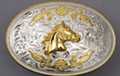 silver and gold tone horse head oval western belt buckle