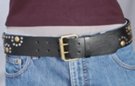 black 1-3/4" wide leather strap belt with antique brass and nickel polish studs rivited in a "mushroom" pattern, antique brass double pickup roller buckle with plain leather keeper