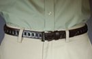 1-1/8" brown leather casual/dress belt; ornamental loops in center, single stitch edge, tabs and keeper; 1-3/4" by 1-1/2" rectangular gray nickel polish buckle
