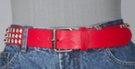 red 1-1/2" leather strap belt with triple row of pyramid metal studs, rectangular roller buckle and leather retainer