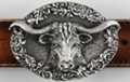 oval pewter belt buckle, Texas longhorn head on wood texture with leaf work