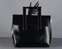 black handbag with flap closure, square handles, and smooth, polished leatherette
