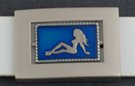 reversible frame belt buckle with mudflap girl and starry scorpion opposing