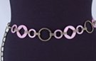chain belt: pink cartwheels and rings, big swirled antique gold rings, all joined by double stippled antique gold chain links which also form the extension chain tipped by another pink ring