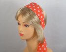 orange headscarf with white polka dots attached to plastic headband