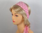 light pink headscarf with white polka dots attached to plastic headband