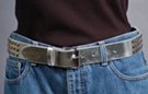 silver 1-1/2" leather strap belt with triple row of pyramid metal studs, rectangular roller buckle and leather retainer
