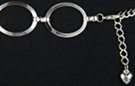silver chain belt comprised of wide center-raised ovals