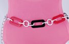 chain belt: 2-1/4" black and red plastic oblongs alternate with small white millstone rings, all bound by smooth white chain links; extension comprises textured silver right chain links tipped by tiny ball