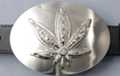 belt buckle, rhinestone studded pot leaf on nickel brush oval