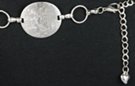 chain belt, curved solid discs alternate with smaller rings
