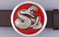 disc belt buckle, chrome rattlesnake on red enamel background