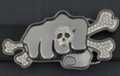 rhinestone belt buckle showing fist with skull and bones
