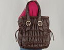 rouched north-south tote, brushed-gold buckles attach double drop shoulder shoulder straps