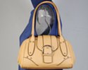 creamy tan small satchel shoulder bag with magnetic saddle flap and ornamental buckle