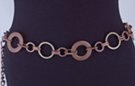 chain belt: collage of sandstone, bronze and gold rings joined by various styles of bronze links; twisted link extension chain tipped by tiny bronze ball