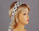 white headscarf with black polka dots attached to plastic headband