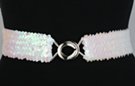 opalescent white sequin stretch belt with silvertone maxi interlocking buckle; has very light pink cast