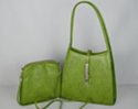green shoulder purse with arching straps and matching clutch