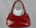 leather handbag with arching shoulder straps have a spade attachment