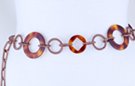 chain belt: swirled bronze circles alternating with large and medium amber rings, all joined by swirled bronze chain links that also form extension with tiny ball at tip