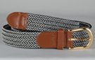 braided knitted stretch belt, each chord in braid knitted from black and white thread, tan leather tabs and brass buckle