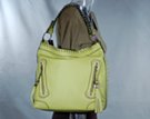 biker-style day bag with nickel studs fore and aft, lacing along top edge and strap, tassels and studs on decorative vertical zipped front pouches