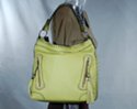 biker-style day bag with nickel studs fore and aft, lacing along top edge and strap, tassels and studs on decorative vertical zipped front pouches
