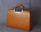 tan brief purse with detachable shoulder sling; zipper close